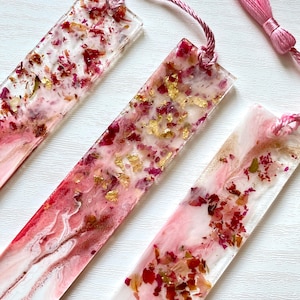 Super close-up of white and pink resin bookmark with dried roses and gold leaf, highlighting intricate handmade details and craftsmanship, personalised and non-personalised options.