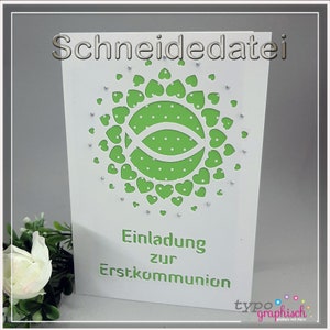 May include: White card with the text "Schneidedatei" at the top. The card has a green and white design with a fish symbol and a circle of hearts. The text "Einladung zur Erstkommunion" is at the bottom of the card.