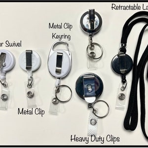 May include: A collection of retractable lanyards and badge holders. The image shows various styles, including those with alligator swivels, metal clips, keyrings, and heavy-duty clips. The lanyards are black, and the badge holders are white or silver.