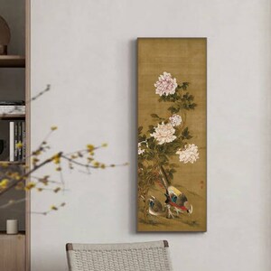 May include: A vertical painting on a gold background with white peonies and two birds. The birds are a pheasant and a smaller bird with a blue head. The painting is framed in a thin black frame.