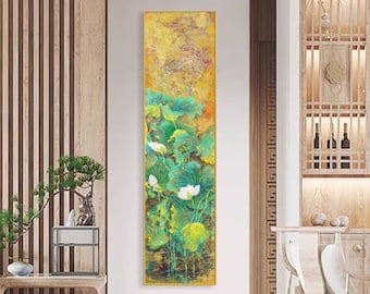 May include: A vertical painting with a gold frame depicting a close-up of white lotus flowers with green leaves on a yellow background.
