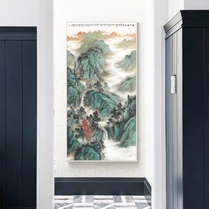 May include: A framed painting depicting a traditional Chinese landscape with mountains, trees, and a flowing river. The painting is done in shades of green, blue, and white, with hints of red and orange.