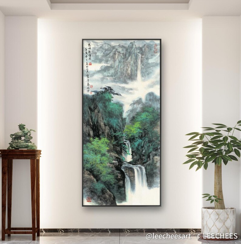 May include: A black and white ink painting of a waterfall cascading down a mountainside. The painting is framed in black and features Chinese calligraphy on the left side.