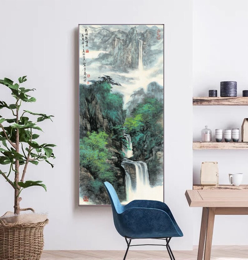 May include: A vertical painting of a waterfall cascading down a mountainside. The painting is done in a traditional Chinese style with brushstrokes and ink. The waterfall is surrounded by lush green trees and mountains. The painting is framed in a simple black frame.