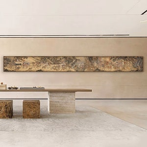 May include: A long, horizontal scroll painting depicting a scene of people and landscapes in a traditional Chinese style. The painting is framed and mounted on a wall in a modern interior.