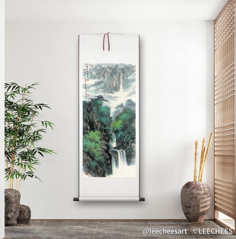 May include: A traditional Chinese scroll painting depicting a waterfall cascading down a mountainside. The painting is done in shades of green, blue, and white, with a misty background. The scroll is mounted on a wooden frame and is ready to be hung.