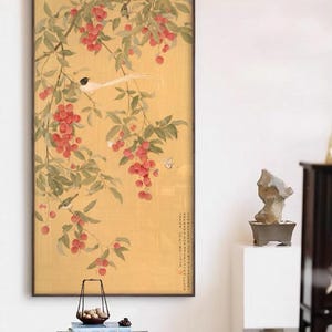 May include: A framed Asian-style painting featuring a branch with red berries, green leaves, and small birds against a yellow background. The artwork has a dark brown frame and includes a small butterfly.