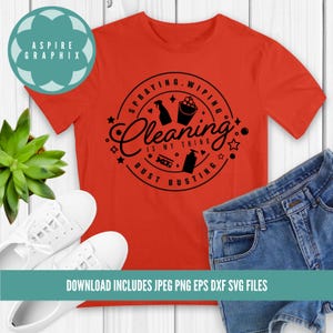 May include: A red t-shirt featuring a black circular design that reads "Spraying, Wiping, Cleaning is my thing, Dust Busting". The design incorporates cleaning icons such as a spray bottle, bucket, and cleaning products.