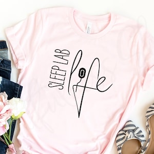 May include: A pink t-shirt with the text "Sleep Lab Life" and a stylised needle and thread graphic.