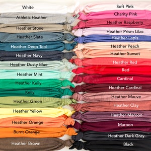 May include: A collection of fabric swatches in various colors and shades, including white, black, red, blue, green, yellow, orange, and brown. The swatches are arranged in two columns, with the names of each color printed below the swatch.