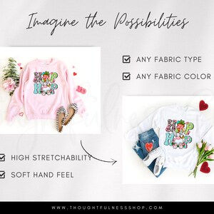 May include: A pink sweatshirt with the text "Hip Hop" in colorful letters and floral accents. The sweatshirt is shown on a white background with a pair of shoes and flowers.