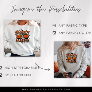 May include: A white sweatshirt with the text "Spooky Mama" in orange and black lettering, featuring a pair of sunglasses with pumpkin eyes and bats flying around. The sweatshirt is shown on a model wearing it and also on a mannequin.