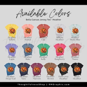 a collection of t-shirts with various colors and designs, including a t-shirt with a pumpkin and fall-themed design.