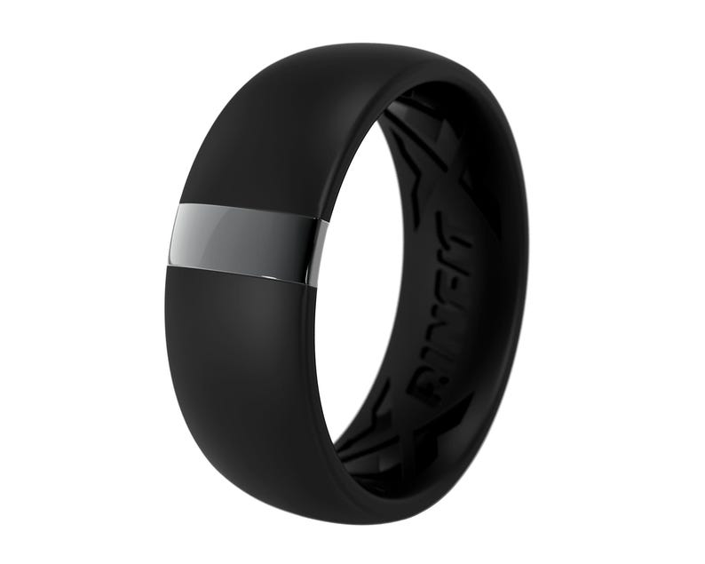 May include: A black silicone ring with a silver band and the word "RINGS" engraved on the side.