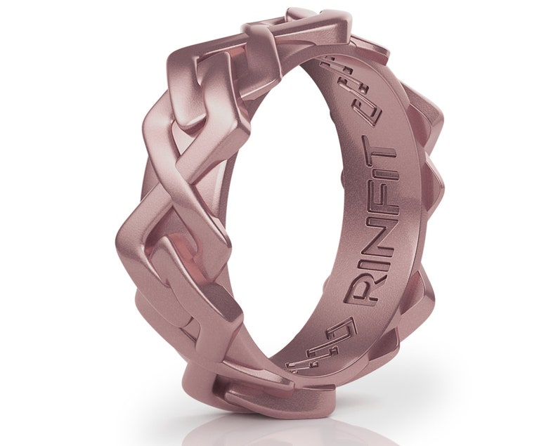 May include: A rose gold silicone ring with a braided design and the word "RINFIT" engraved on the inside.