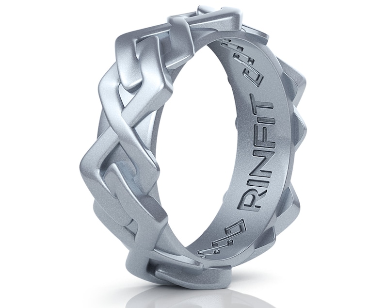 May include: A silver ring with a braided design and the word "RINFIT" engraved on the inside.