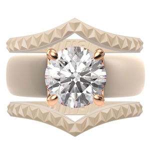 May include: A three-piece ring set featuring a large, round-cut diamond held by rose gold prongs. The center ring is a smooth, cream-colored band, flanked by two chevron-shaped bands with textured, geometric detailing. The rings are set against a white background.