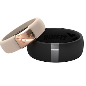 May include: Two silicone rings, one black with a silver stripe and the word "RINFIT" printed on it, and one beige with a rose gold band and a diamond-shaped logo.