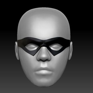 May include: A gray sculpted face with a black eye mask. The mask has a rounded shape with a slight curve at the top and bottom.