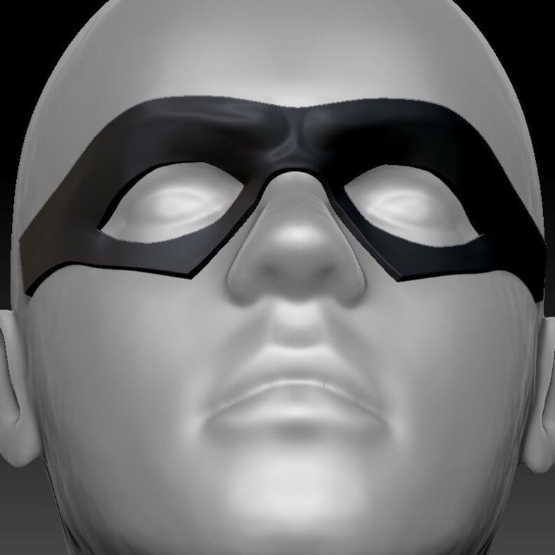 May include: A close-up of a person wearing a black eye mask. The mask covers the eyes and part of the nose. The mask has a curved shape and is made of a smooth material.
