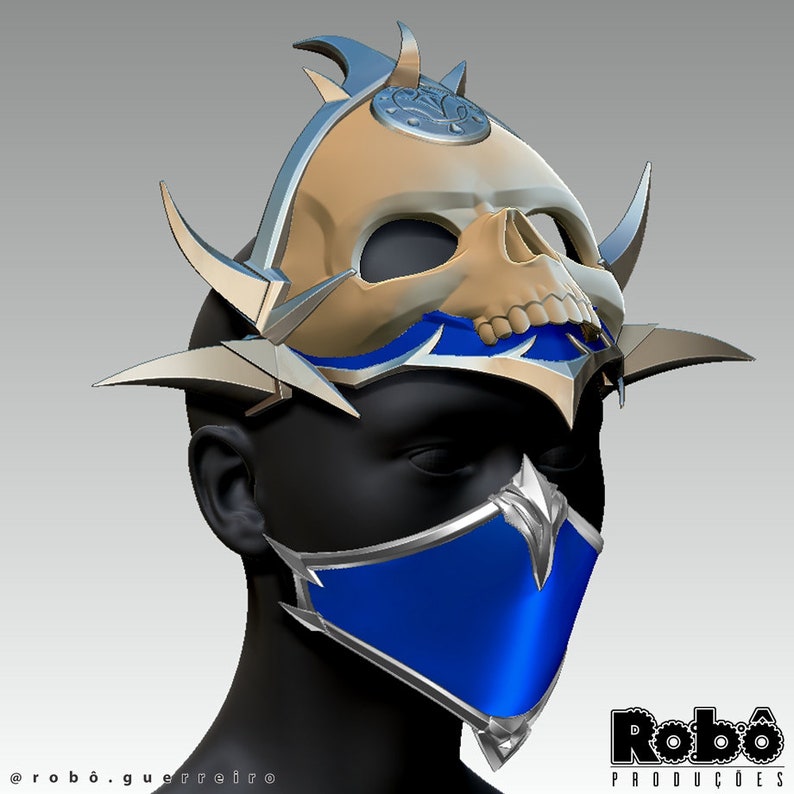 May include: A blue and silver mask with a skull design. The mask has a pointed top and a long, flowing tail. The mask is worn on a mannequin's head.