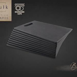 May include: A stack of 10 black fiber cutting boards with a handle. The boards are dishwasher safe.