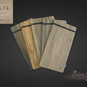 May include: A set of six blue pine wood cutting boards with black elastic bands. The boards are arranged in a fan shape and have a natural wood grain. The text "Bulk Cutting Boards" is in the top left corner of the image. The text "Blue Pine Wood" is in the bottom right corner of the image.