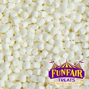 May include: A close-up image of a large quantity of small, white marshmallows. The marshmallows are arranged in a random pattern, creating a textured background. The image is labeled with the text "Funfair Treats, Hand Crafted in Small Batches".