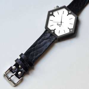 A hexagon wood watch with black leather strap