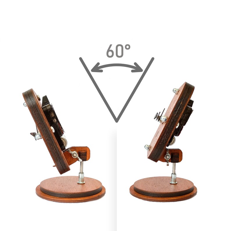 May include: A wooden phone stand with a rotating base, allowing the phone to be positioned at a 60-degree angle. The stand is made of dark wood with a natural finish.