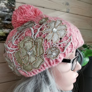 Bobble Hat. Pink, sparkly, embellished, pompom, chunky cable-knit. Knitted. 100% Acrylic. One size fits all.