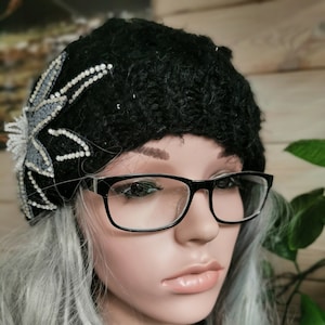 Bobble Hat. Black, sparkly, embellished, pompom, chunky cable-knit. Knitted. 100% Acrylic. One size fits all.