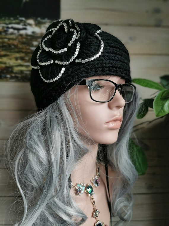 Black, sparkly, embellished, chunky cable-knit headband. Knitted. 100% Acrylic. One size fits all. Button fastening at back.