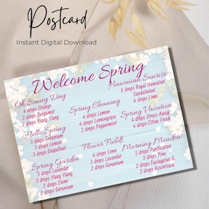 May include: A blue and white postcard with the text "Welcome Spring" in pink. The postcard features a list of essential oil blends for different spring activities, such as "Oh Sunny Day", "Spring Cleaning", "Hello Spring", "Spring Garden", "Hawaiian Sunrise", "Spring Vacation", "Flower Fields", and "Morning Meadow".