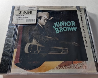 CD de Junior Brown "12 Shades Of Brown", álbum de guitarra de acero de 1993 (nuevo y sellado)