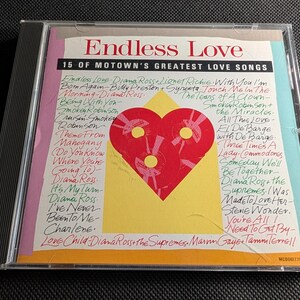 May include: A clear plastic CD case featuring the album Endless Love: 15 of Motown's Greatest Love Songs. The cover art displays a red heart graphic over a yellow background, surrounded by a list of song titles and artists in handwritten script.
