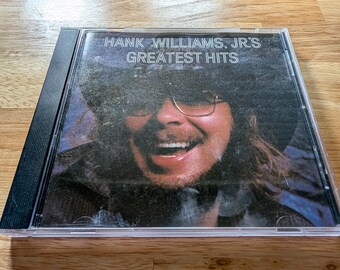 CD de grandes éxitos de Hank Williams Jr. Clásicos del country 2008 Excelente disco