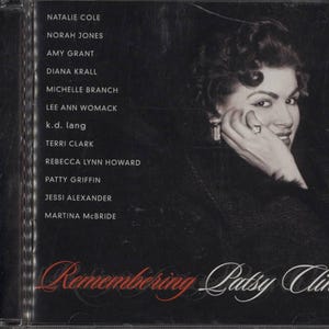 May include: CD case for "Remembering Patsy Cline" with a black and white image of a woman. The cover lists artists including Natalie Cole and Norah Jones. The title is in red script.
