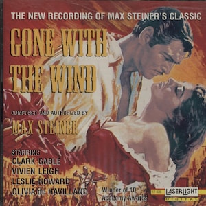 May include: CD cover for "Gone With The Wind" featuring Clark Gable and Vivien Leigh. The cover art depicts a romantic scene with the film's title in large, gold letters. The CD case also lists the composer, Max Steiner, and the film's stars.