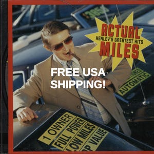 May include: CD case with a retro design featuring a man in a suit and sunglasses, holding a cigar. The text on the CD case reads "ACTUAL MILES" and "HENLEY'S GREATEST HITS". The image also includes the text "FREE USA SHIPPING!"