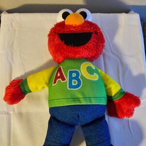 Singing abc elmo doll top