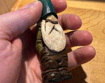 Sculpture of a small green gnome in hand-carved wood by David Therrien, a Quebec artist.