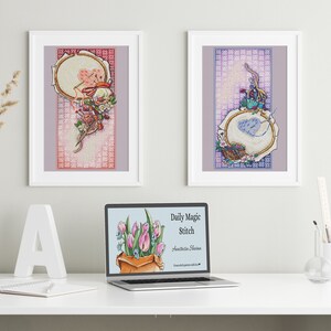 May include: Two framed cross-stitch artworks with floral and embroidery hoop designs. A laptop displays the text "Daily Magic Stitch" and a bouquet of tulips. The scene is set on a white desk with decorative elements.