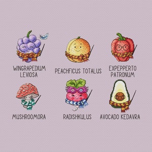 May include: Cross-stitch art featuring six whimsical food items: grapes, pumpkin, pepper, mushroom, radish, and avocado. Each is adorned with a scarf, glasses, and a wand, with text below each. The background is a light purple fabric.