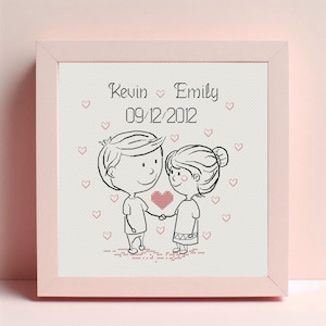May include: A white framed picture with a black and white illustration of a couple holding a heart. The text "Kevin Emily 09/12/2012" is printed above the couple.