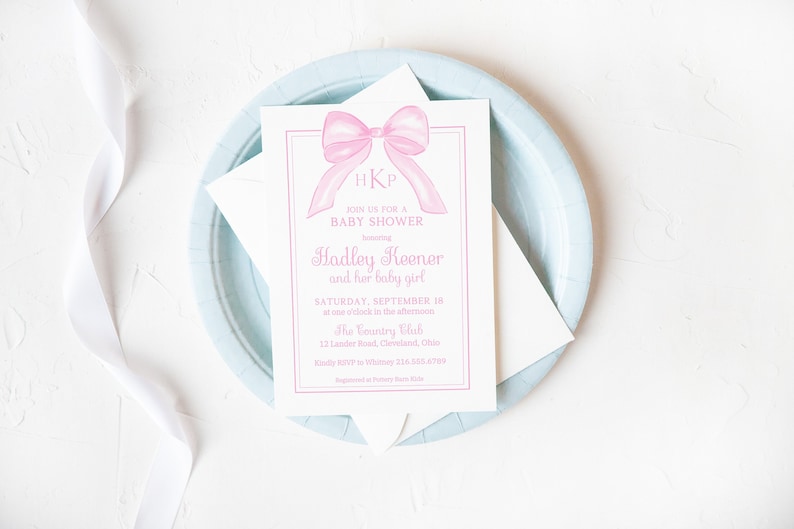 May include: A pink baby shower invitation with a watercolor illustration of a pink bow and the initials "HKP". The invitation text reads "Join us for a baby shower honoring Hadley Keener and her baby girl. Saturday, September 18 at one o'clock in the afternoon. The Country Club, 12 Lander Road, Cleveland, Ohio."