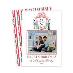 May include: A rectangular Christmas card featuring a watercolor crest with a letter C, nutcrackers, and a rocking horse. Below is a photograph of a family of four, with the text MERRY CHRISTMAS, The Chandler Family, and the year 2026 printed below.