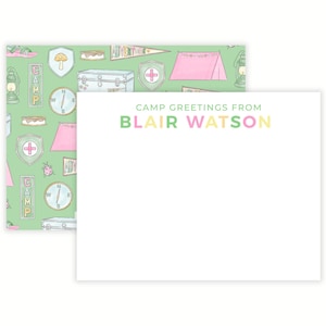 May include: A stationery set featuring a patterned design with camping-themed illustrations in green, pink, and white. The set includes a notepad with the text "CAMP GREETINGS FROM BLAIR WATSON" in pastel colors.