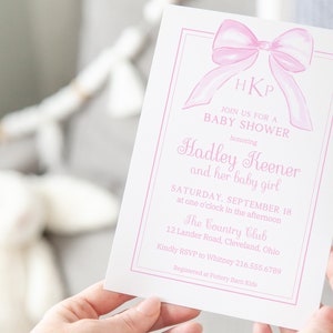 May include: Pink baby shower invitation with a watercolor bow and the text "HKP JOIN US FOR A BABY SHOWER honoring Hadley Keener and her baby girl SATURDAY, SEPTEMBER 18 at one o'clock in the afternoon The Country Club 12 Lander Road, Cleveland, Ohio Kindly RSVP to Whitney 216.555.6789 Registered at Pottery Barn Kids"