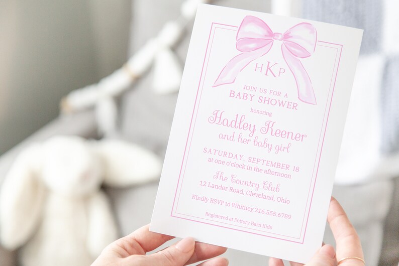 May include: Pink baby shower invitation with a watercolor bow and the text "HKP JOIN US FOR A BABY SHOWER honoring Hadley Keener and her baby girl SATURDAY, SEPTEMBER 18 at one o'clock in the afternoon The Country Club 12 Lander Road, Cleveland, Ohio Kindly RSVP to Whitney 216.555.6789 Registered at Pottery Barn Kids"